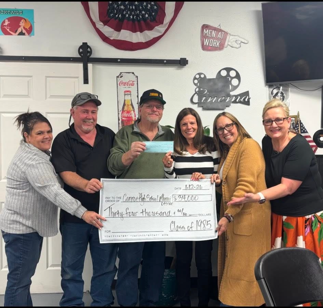 Conroe High School Class of 1985 alumni presenting a $34,000 donation check to the CHS Alumni Association